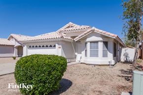 Peoria house for rent - a white house with a yard and a garage