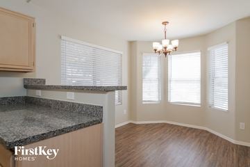 Peoria house for rent - a kitchen and dining room with a hard wood floor and a granite counter top