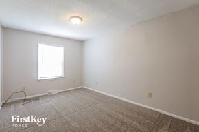 Kansas City house for rent - a bedroom with white walls and carpet and a window