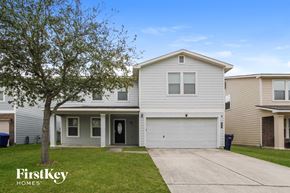 Baytown house for rent - a white house with a driveway and a tree