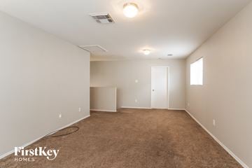 Baytown house for rent - a living room with carpet and a door to a closet