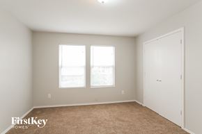 Baytown house for rent - a bedroom with two windows and a door