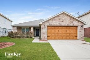 Fort Worth house for rent - home with a brown garage door on a brick house