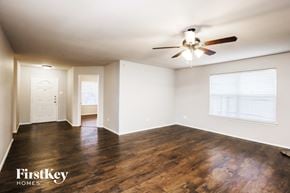 Fort Worth house for rent - an empty living room with wood flooring and a ceiling fan