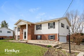 West Chester house for rent - a white and brick house with a yard in front of it