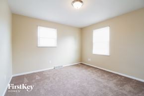 West Chester house for rent - a spacious room with carpet and two windows