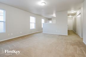 Camby house for rent - the living room and dining room of an apartment with carpeting and white walls