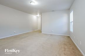 Camby house for rent - the living room and dining room of an apartment with white walls and flooring
