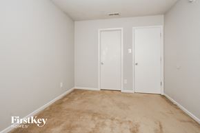 Camby house for rent - a bedroom with white walls and carpet and two doors