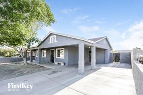 Phoenix house for rent - A house with a grey roof and a tree in front of it.