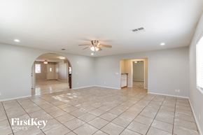 Phoenix house for rent - A spacious empty room with a fan on the ceiling.