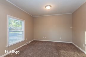 Charlotte house for rent - the second bedroom with carpeted flooring and a large window