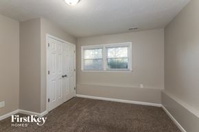 Charlotte house for rent - a bedroom with carpet and a door and a window