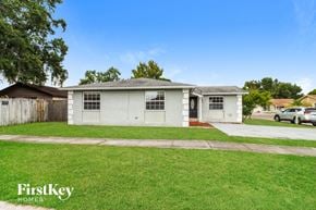 Tampa house for rent - a white house with a lawn and a sidewalk