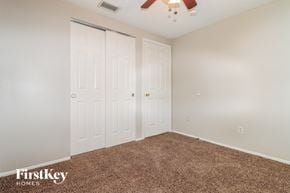 Tampa house for rent - a bedroom with two closets and a ceiling fan