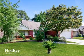 Humble house for rent - a home with a lawn and trees in front of it