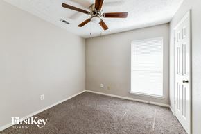 Humble house for rent - the bedroom has a ceiling fan and a carpeted floor
