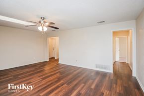 North Richland Hills house for rent - A room with wooden floors and a ceiling fan.