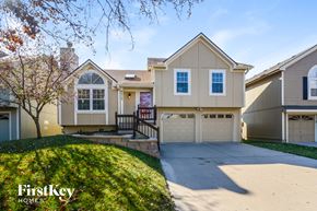 Kansas City house for rent - a beige house with a driveway and a garage door