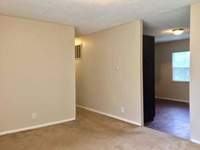 Indianapolis house for rent - an empty living room with white walls and a window