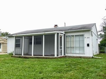 Indianapolis house for rent - a small white house with a porch and a lawn