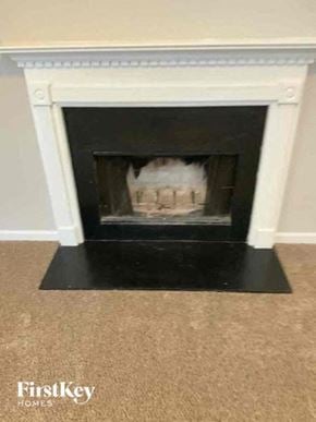 Snellville house for rent - a fireplace in a living room with a cake in it