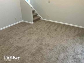 Snellville house for rent - a carpeted floor in a room with stairs