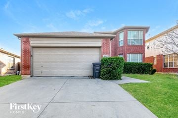 Fort Worth house for rent - a garage door in front of a brick house