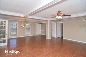 Cordova house for rent - an empty living room with wood floors and a ceiling fan