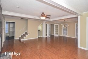 Cordova house for rent - an empty living room with a ceiling fan