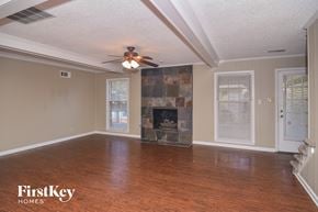 Cordova house for rent - a living room with a fireplace and a ceiling fan