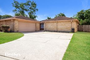 Humble house for rent - a home with two garages and a driveway