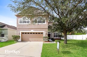 Riverview house for rent - a house with a garage door and a tree