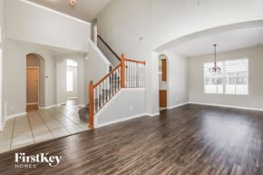 Riverview house for rent - an empty living room with a staircase in the corner