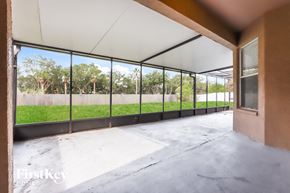 Riverview house for rent - a view of a patio from the inside of a building with large glass windows