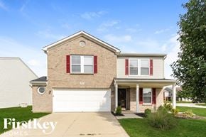 Camby house for rent - a brick house with red shutters and a white garage door