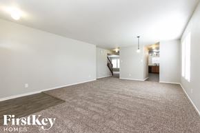 Camby house for rent - an empty living room with a rug and white walls