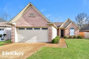 Cordova house for rent - A house with a brick facade and a white garage door.