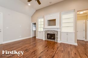 Cordova house for rent - A spacious living room with a fireplace and built-in cabinets.
