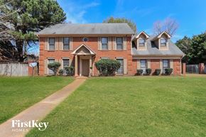Cordova house for rent - a large brick house with a lawn in front of it