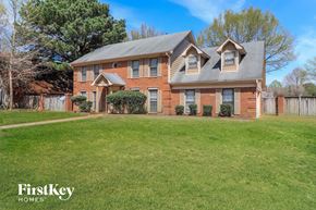 Cordova house for rent - a large brick house with a yard in front of it