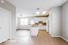 Houston house for rent - an empty kitchen with white cabinets and white appliances