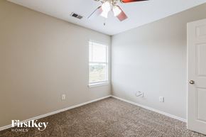 Houston house for rent - a bedroom with a carpeted floor and a ceiling fan