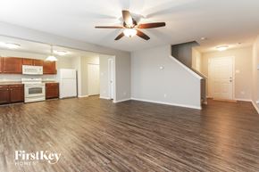 Camby house for rent - A spacious living room with a wood floor and a ceiling fan.