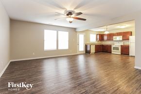 Camby house for rent - A spacious room with wooden floors and a ceiling fan.