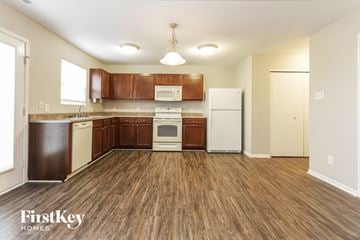 Camby house for rent - A kitchen with wooden floors and brown cabinets.