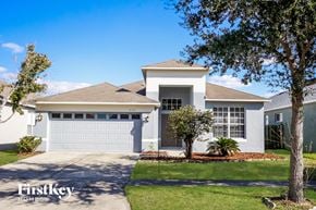 Riverview house for rent - a white house with a garage door and a lawn