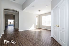 Riverview house for rent - an empty living room with white walls and wood floors