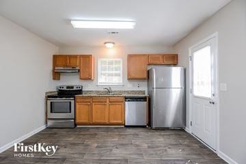 Charlotte house for rent - A kitchen with wooden cabinets and stainless steel appliances.