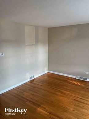 Chicago house for rent - an empty room with wooden floors and white walls